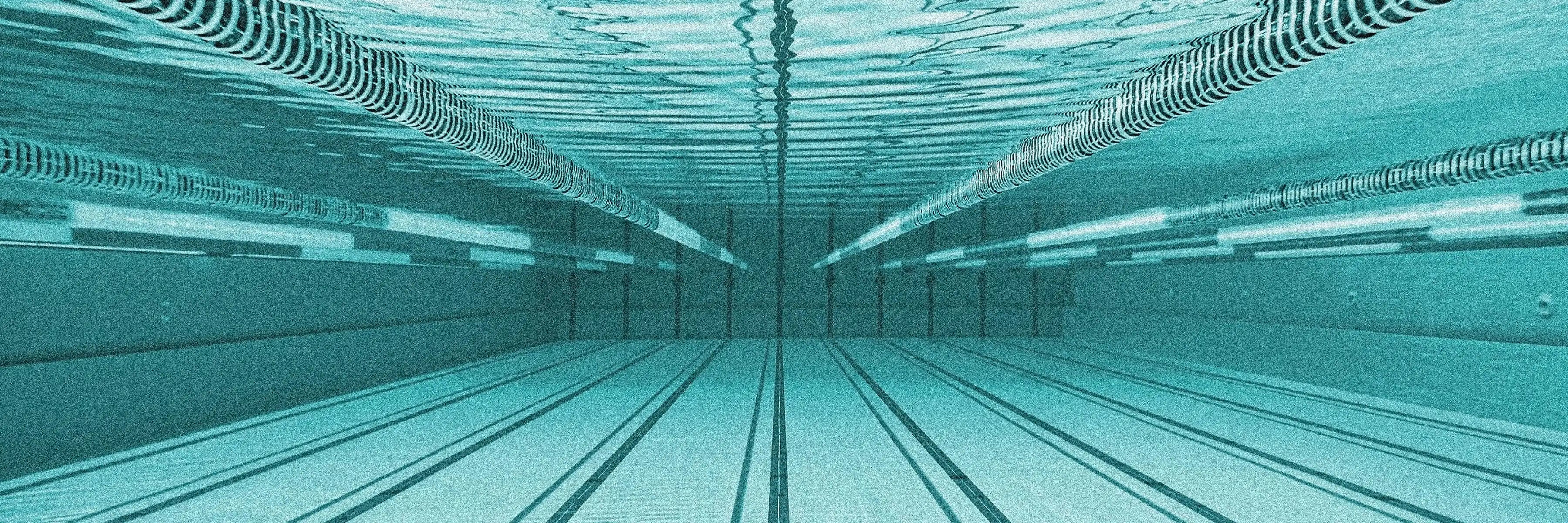 grainy, artistic, underwater photo of an olympic swimming pool