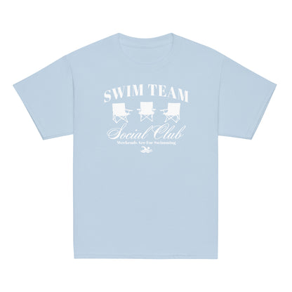 Light blue Swim Team Social Club Youth T-shirt by TrendySwimmer with white foldable chair design and swim club slogan.