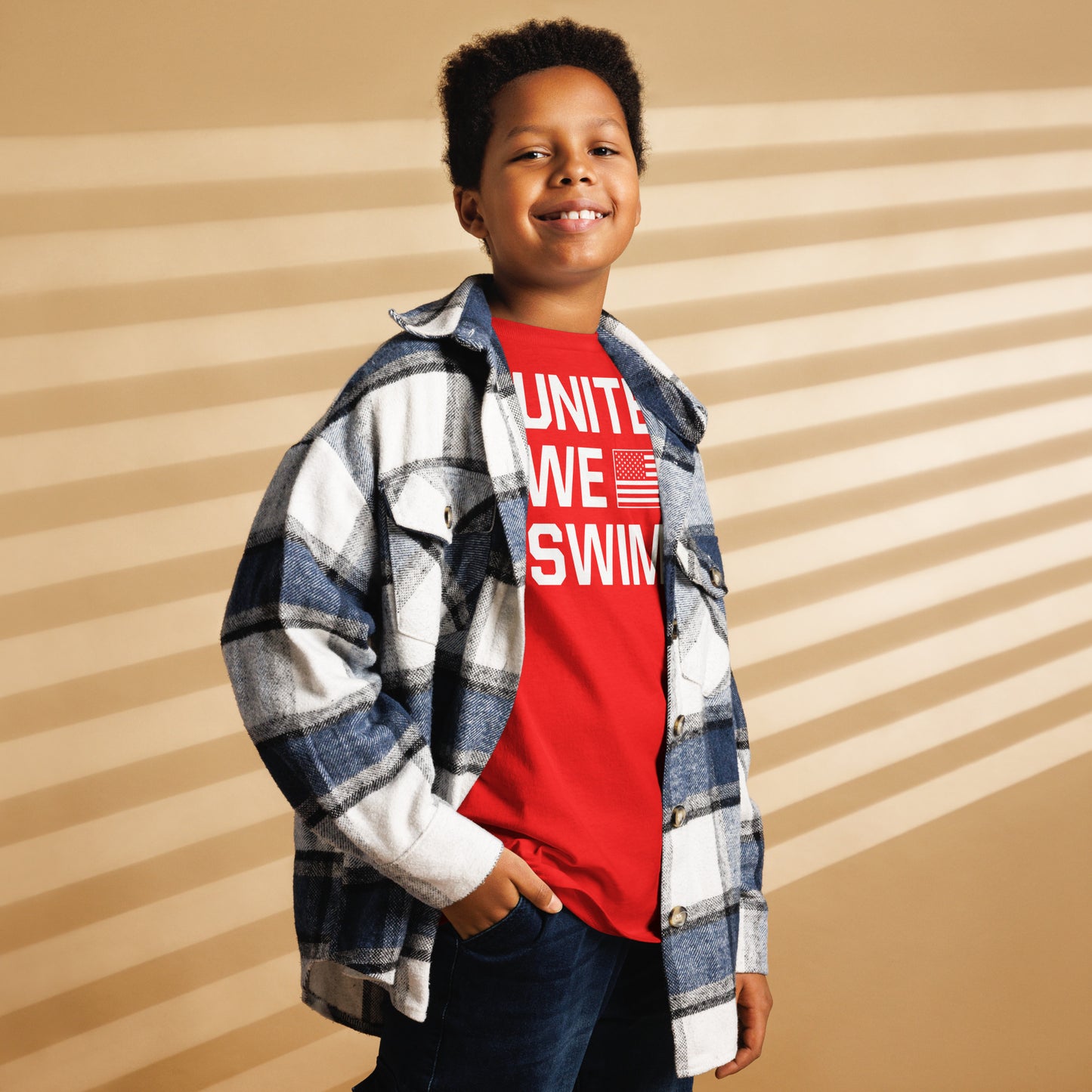 Boy layering red United We Swim Patriotic Youth T-Shirt with plaid shirt, showcasing versatile swim youth apparel for casual wear.