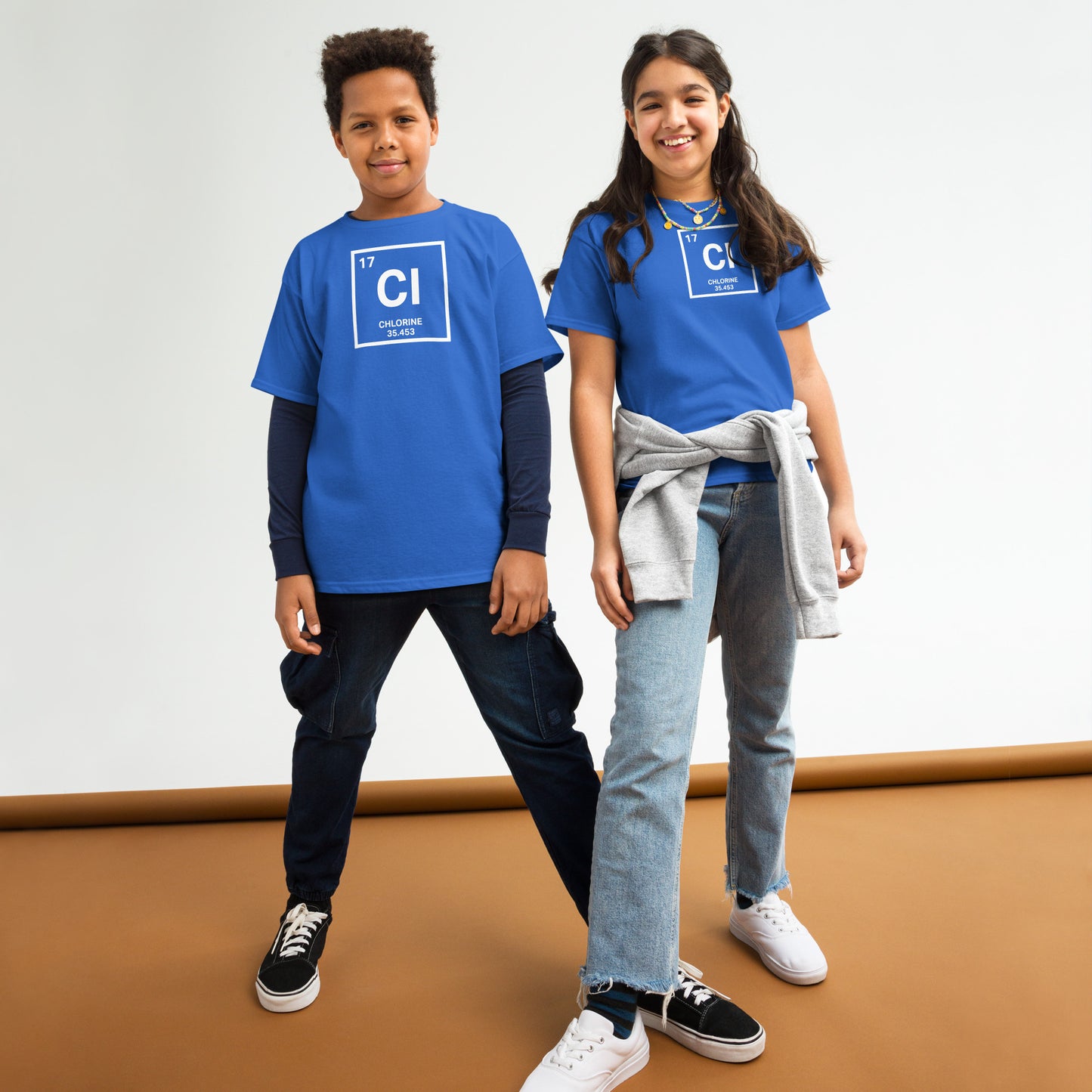Two kids wearing YOUTH Funny Swimmers Chlorine Periodic Table Symbol T-Shirts in blue, styled casually for swim team or school wear.