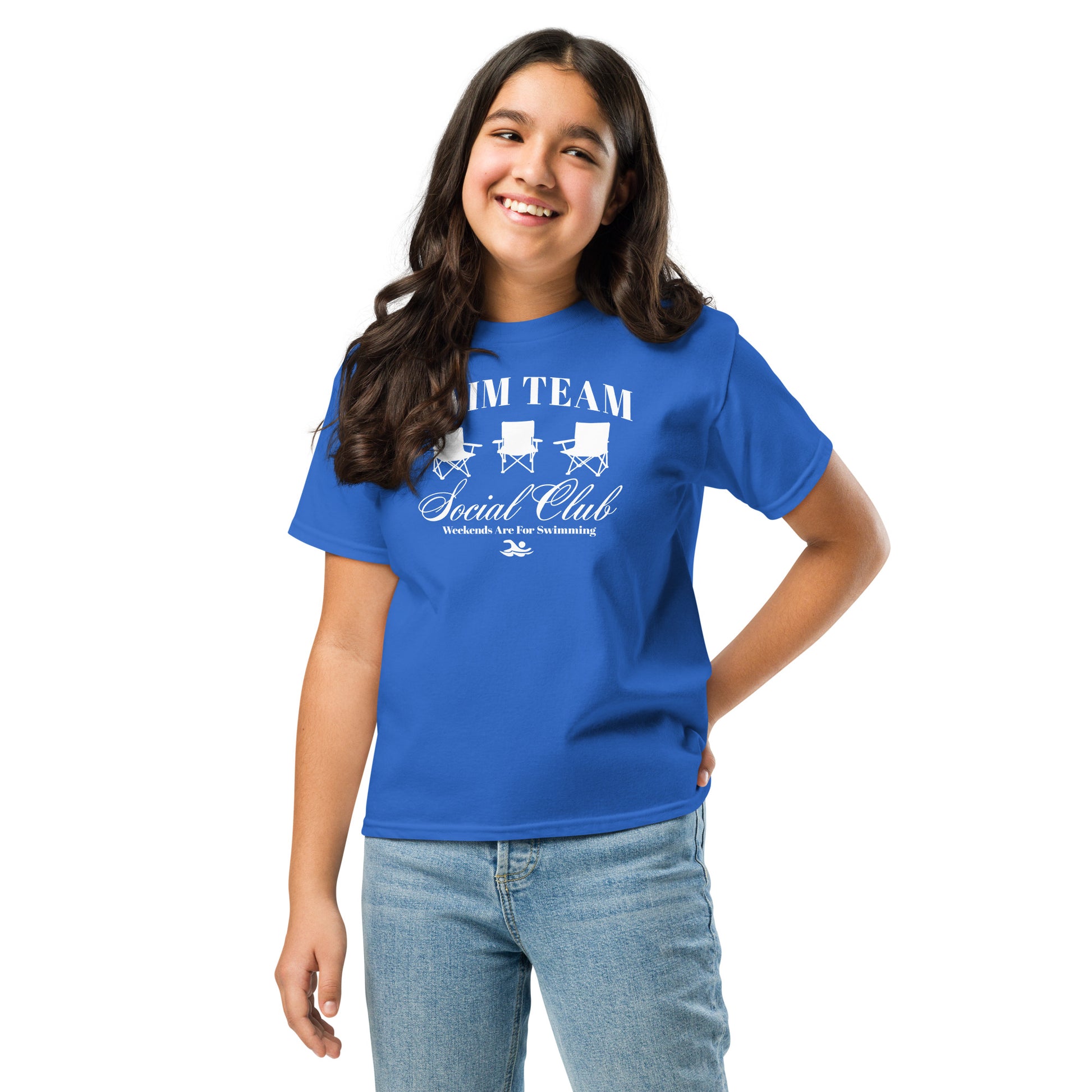 Girl modeling royal blue Swim Team Social Club Youth T-shirt by TrendySwimmer with fun foldable chair design and swim-themed print.