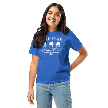 Girl modeling royal blue Swim Team Social Club Youth T-shirt by TrendySwimmer with fun foldable chair design and swim-themed print.